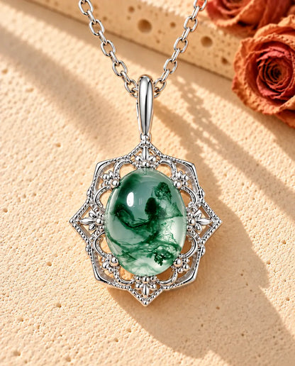 Collier Pendentif Agate Mousse Vintage en Argent 925 - posé sur une surface claire texturée près d’un bloc de travertin