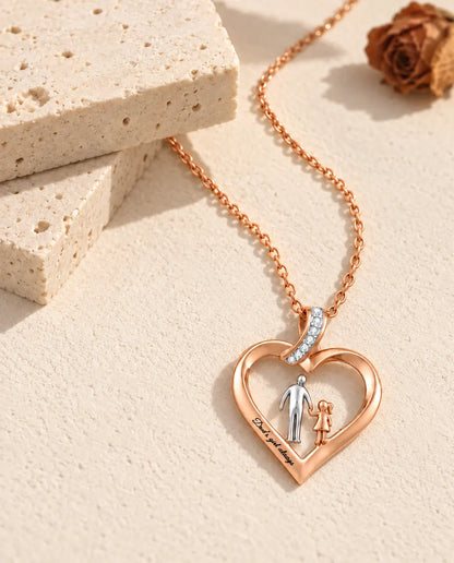 Pendentif cœur papa et fille avec sa bélière en ruban sertie d'oxydes de zirconium, de biais sur du plâtre
