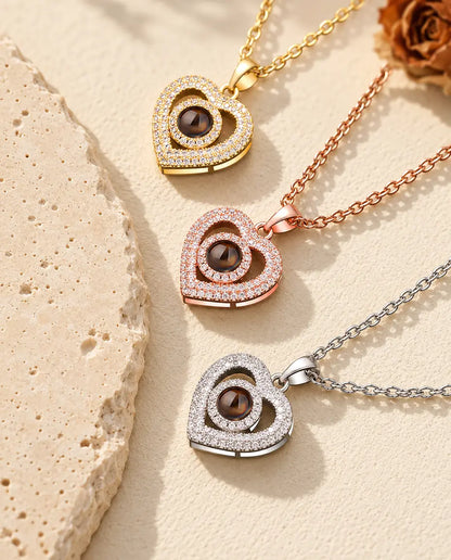 Pendentifs double cœur doré, couleur or rose et argenté superposés près du travertin