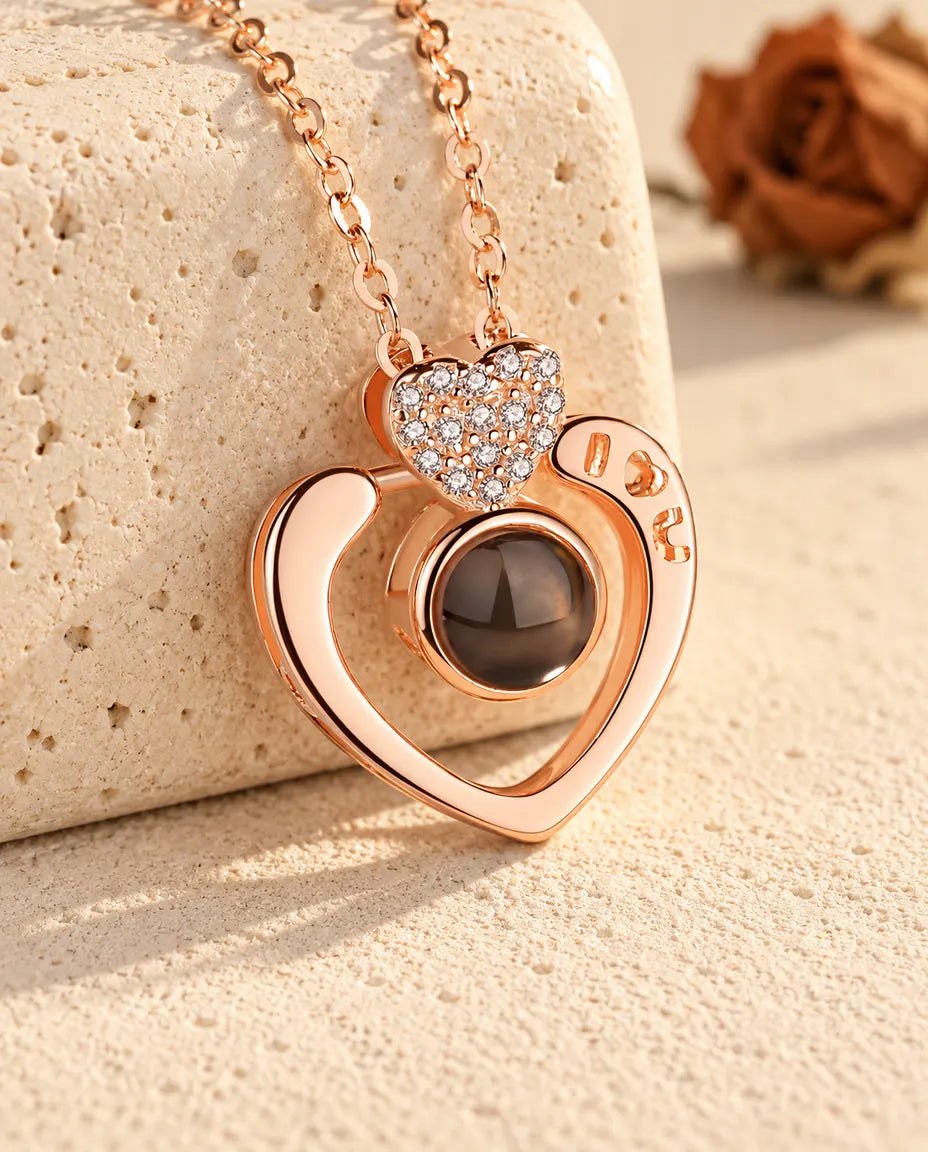 Collier cœur ouvert photo projection personnalisé couleur or rose contre un bloc de travertin