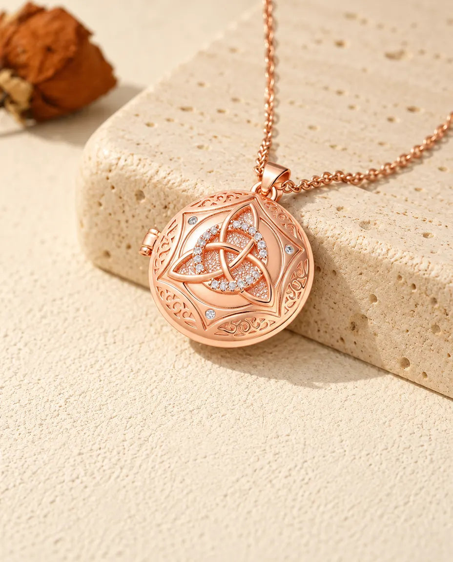 Médaillon photo couleur or rose à nœud celtique et cercle de zircons posé sur du travertin